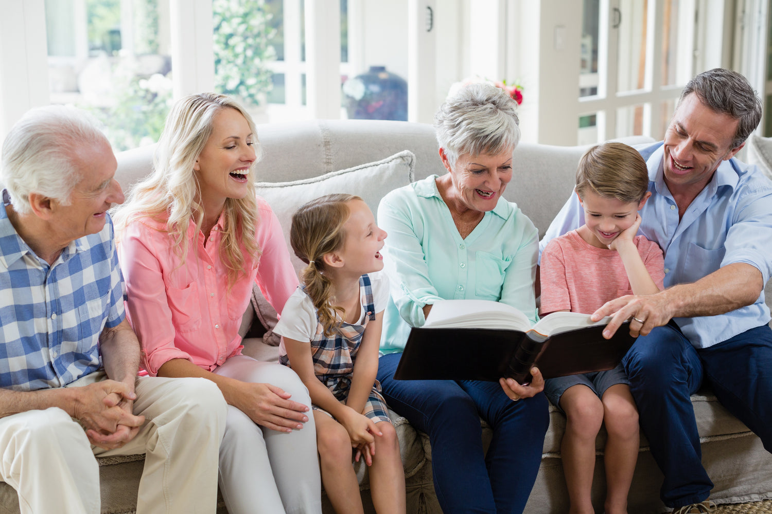 3 generations on couch with album